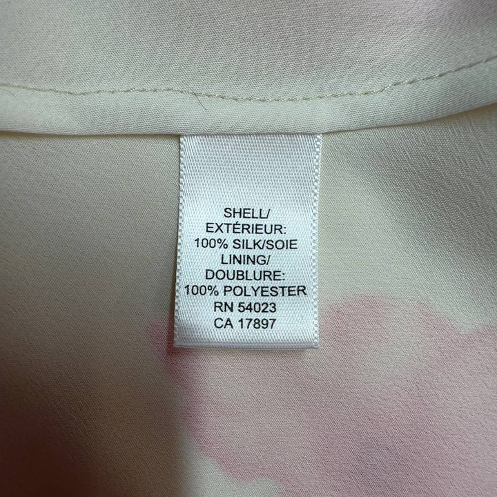 Tag view of cream floral Banana Republic top showing botanical print pattern and three-quarter sleeve detail