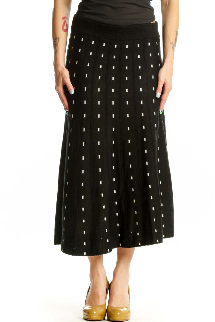 Black A-line midi skirt with white polka dot pattern, front view