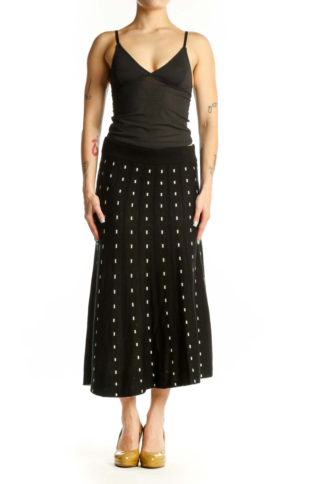 Black A-line midi skirt with white polka dot pattern, front view