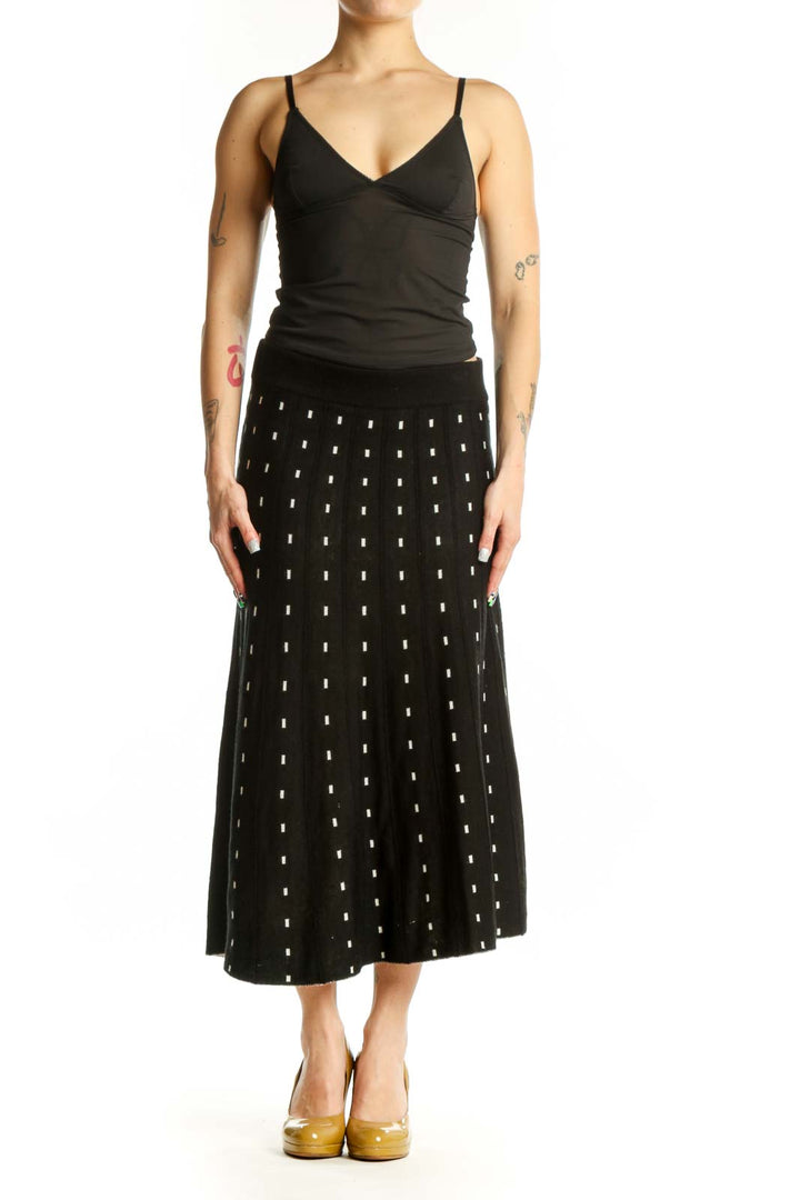 Black A-line midi skirt with white polka dot pattern, front view