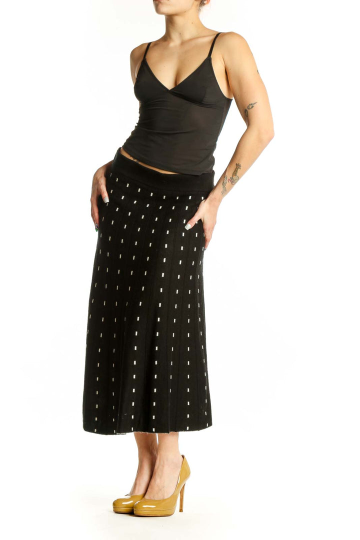 Black A-line midi skirt with white polka dot pattern, front view