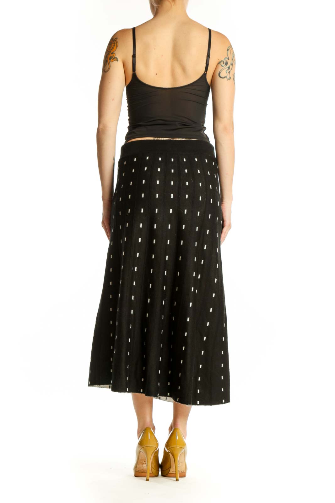 Black A-line midi skirt with white polka dot pattern, back view