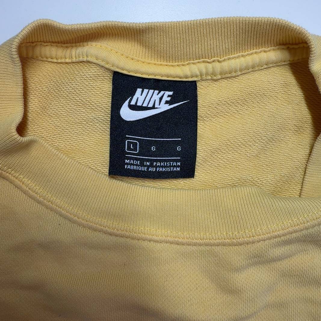 Yellow Nike cropped athletic t-shirt back view showing relaxed fit and cropped length