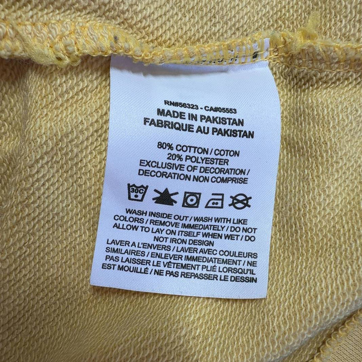 Yellow Nike cropped athletic t-shirt back view showing relaxed fit and cropped length