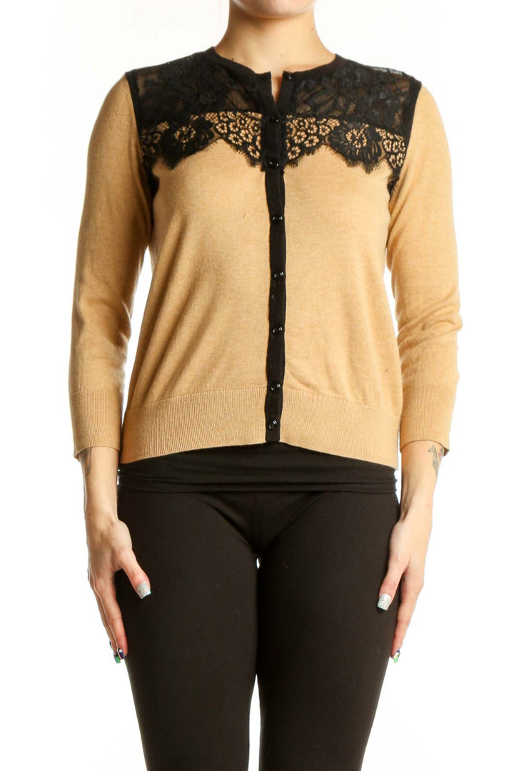 Beige cardigan with black lace trim neckline, three-quarter sleeves, and button-front closure