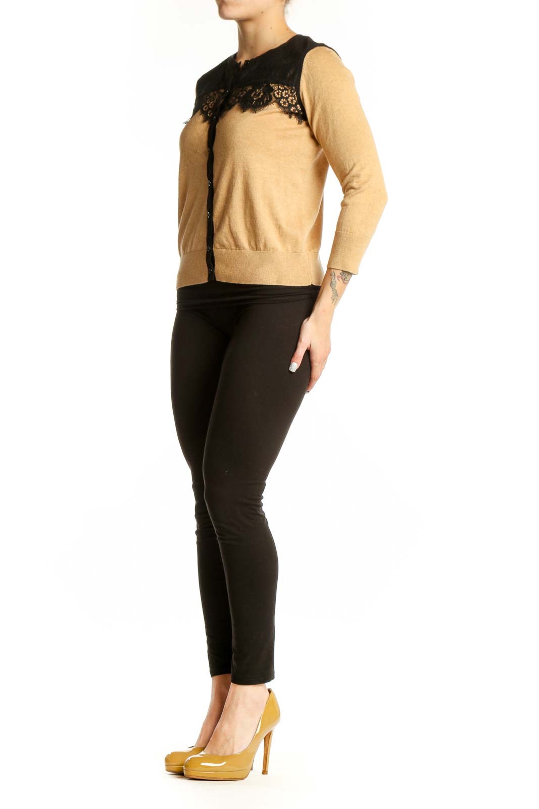 Beige cardigan with black lace trim neckline, three-quarter sleeves, and button-front closure