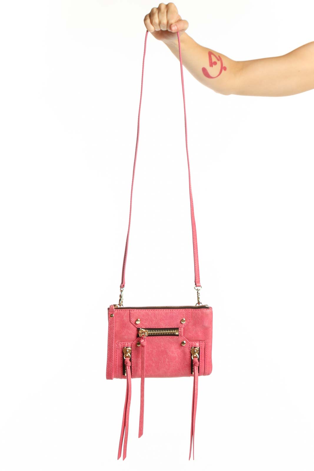 Coral pink Botkier leather crossbody bag with gold hardware and fringe details, shown with adjustable pink leather strap