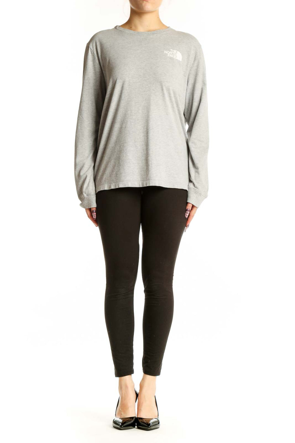 Gray long sleeve The North Face tee with white logo on chest, worn with black leggings