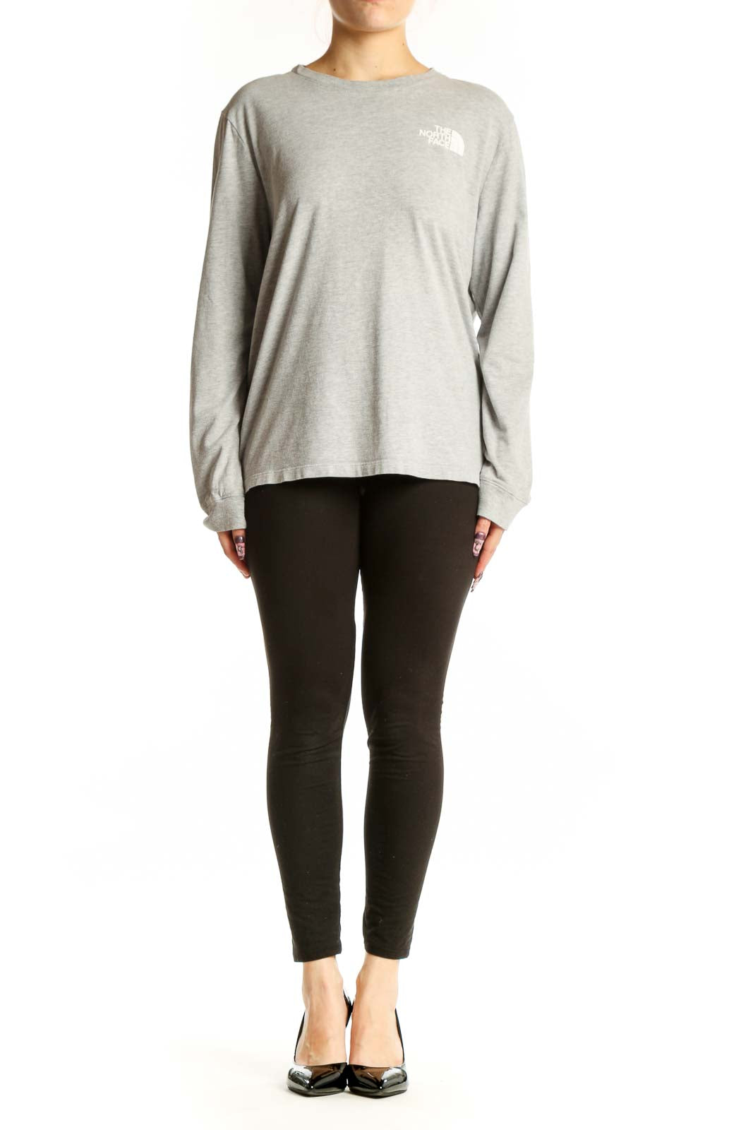 Gray long sleeve The North Face tee with white logo on chest, worn with black leggings