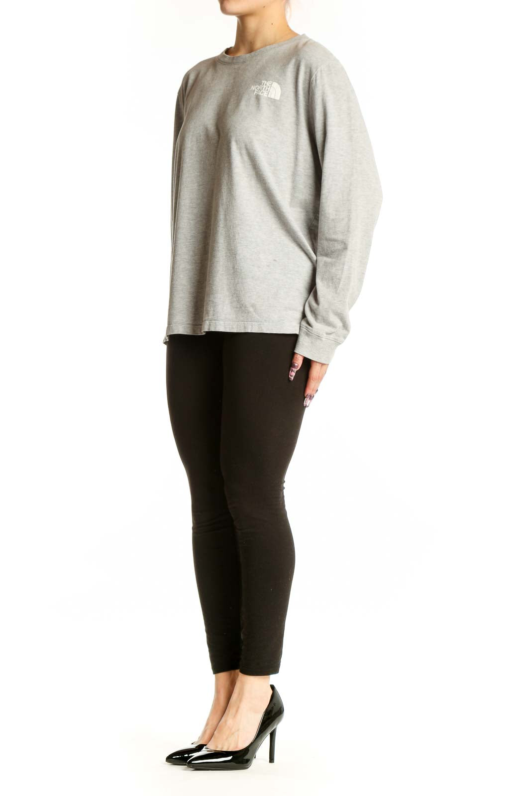 Gray long sleeve The North Face tee with white logo on chest, worn with black leggings