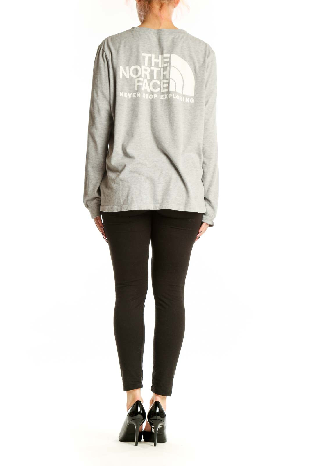 Back view of gray long sleeve The North Face top showing white logo, paired with black leggings