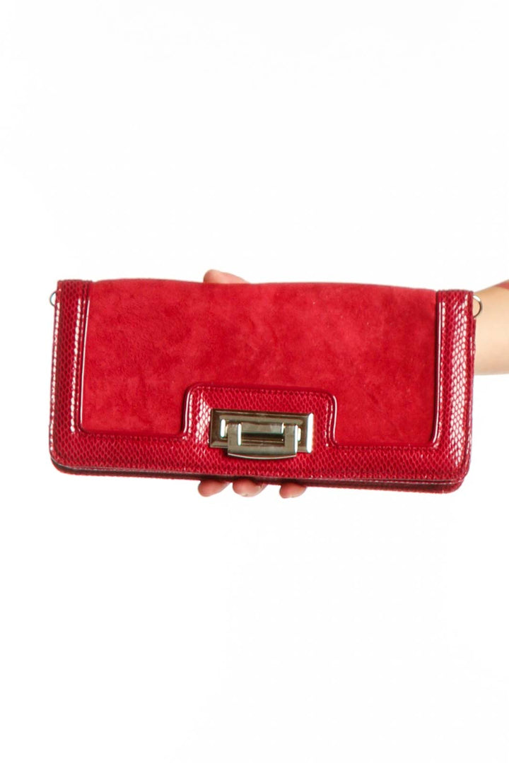 Red leather clutch with textured suede sides and gold-tone flip-lock hardware by White House Black Market