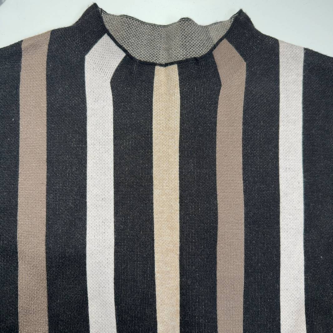 Tag view of black striped sleeveless tank top showing vertical stripe pattern and fitted back design