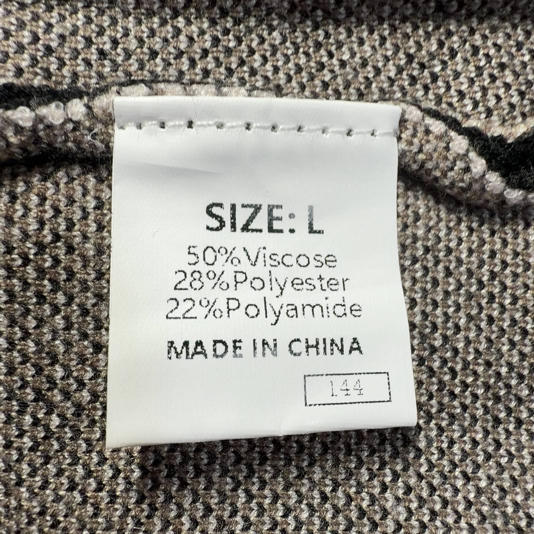 Tag view of black striped sleeveless tank top showing vertical stripe pattern and fitted back design
