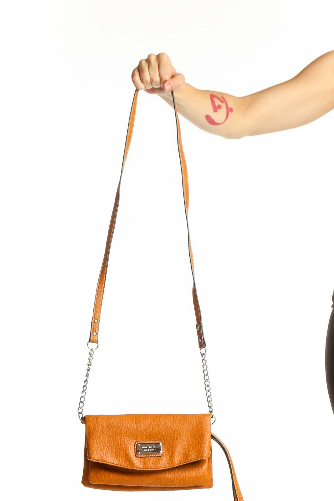 Orange leather crossbody bag by Nine West with chain and leather straps, front view