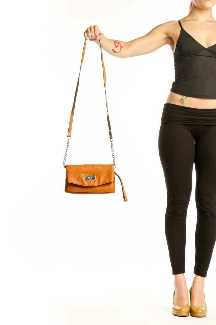Orange leather crossbody bag by Nine West with chain and leather straps, front view