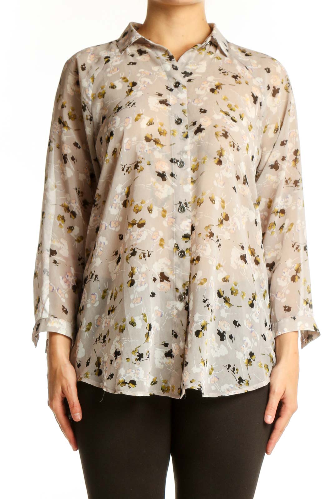 Cream floral print button-up shirt with gold and black botanical pattern, long sleeves, and classic collar on model