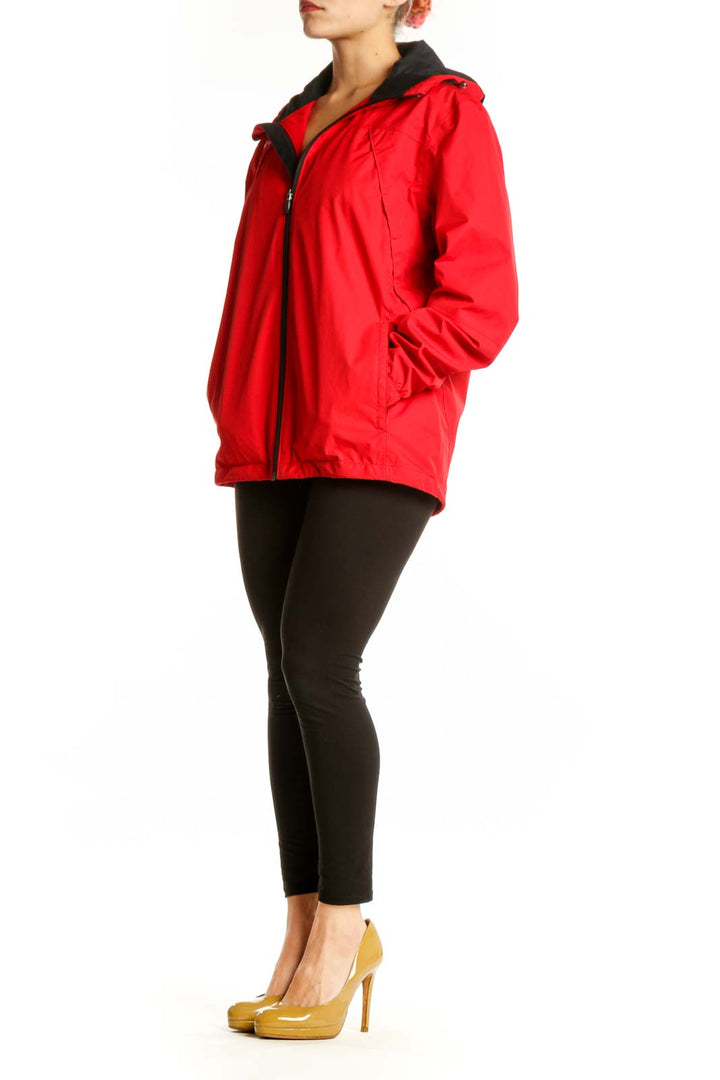 Red Asics windbreaker jacket with black hood and collar, front view on model
