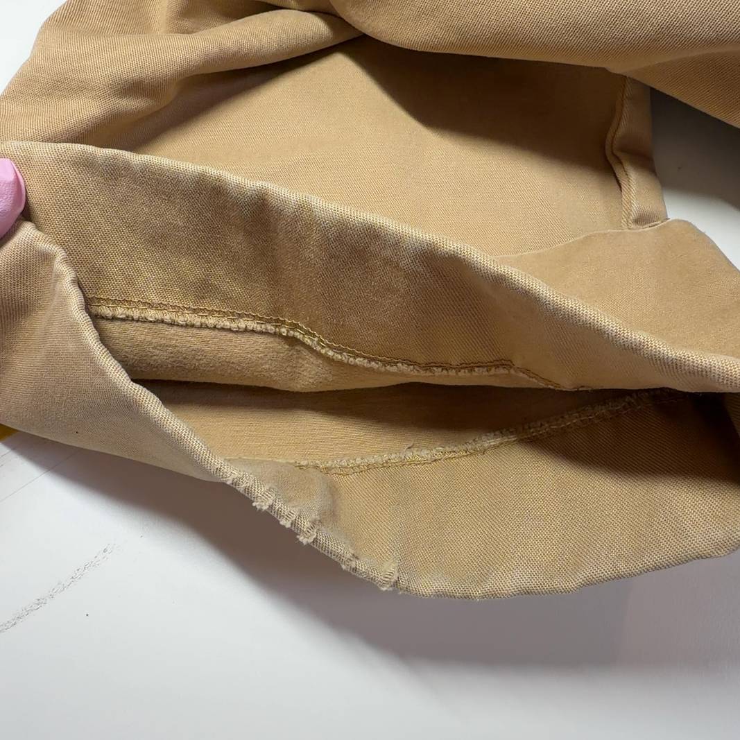 Beige cargo cropped cotton pants with rolled cuffs, back view