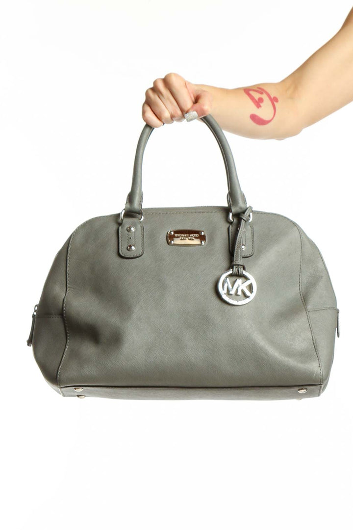 Gray Michael Kors dome tote bag with dual handles and MK charm, front view
