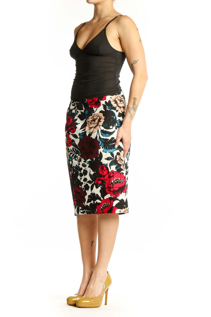 Adrianna Papell multicolor floral pencil skirt front view featuring red peonies, cream blooms, and teal accents on black background
