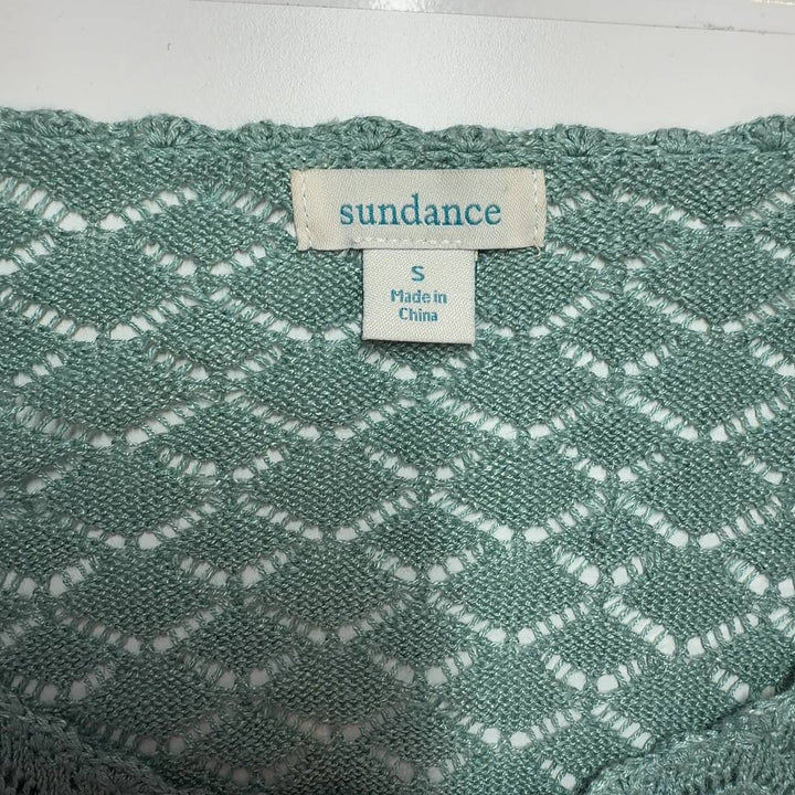 Tag view of sage green Sundance ruffle cardigan showing textured knit pattern and ribbed hem