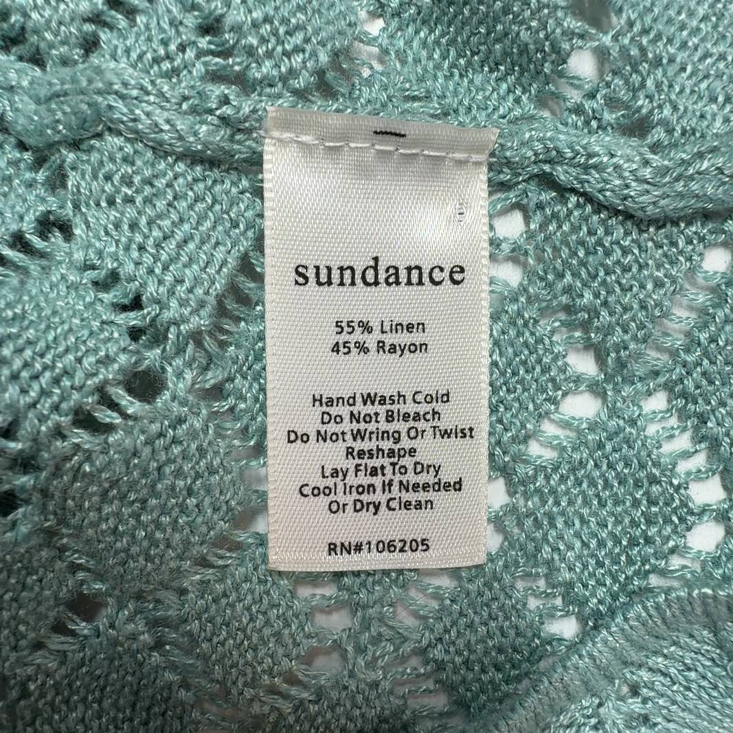 Tag view of sage green Sundance ruffle cardigan showing textured knit pattern and ribbed hem