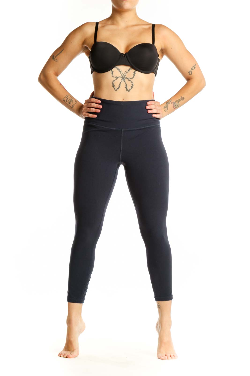 Black high-waist capri leggings front view showing fitted silhouette and wide waistband