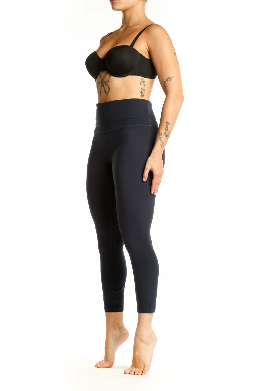 Black high-waist capri leggings front view showing fitted silhouette and wide waistband