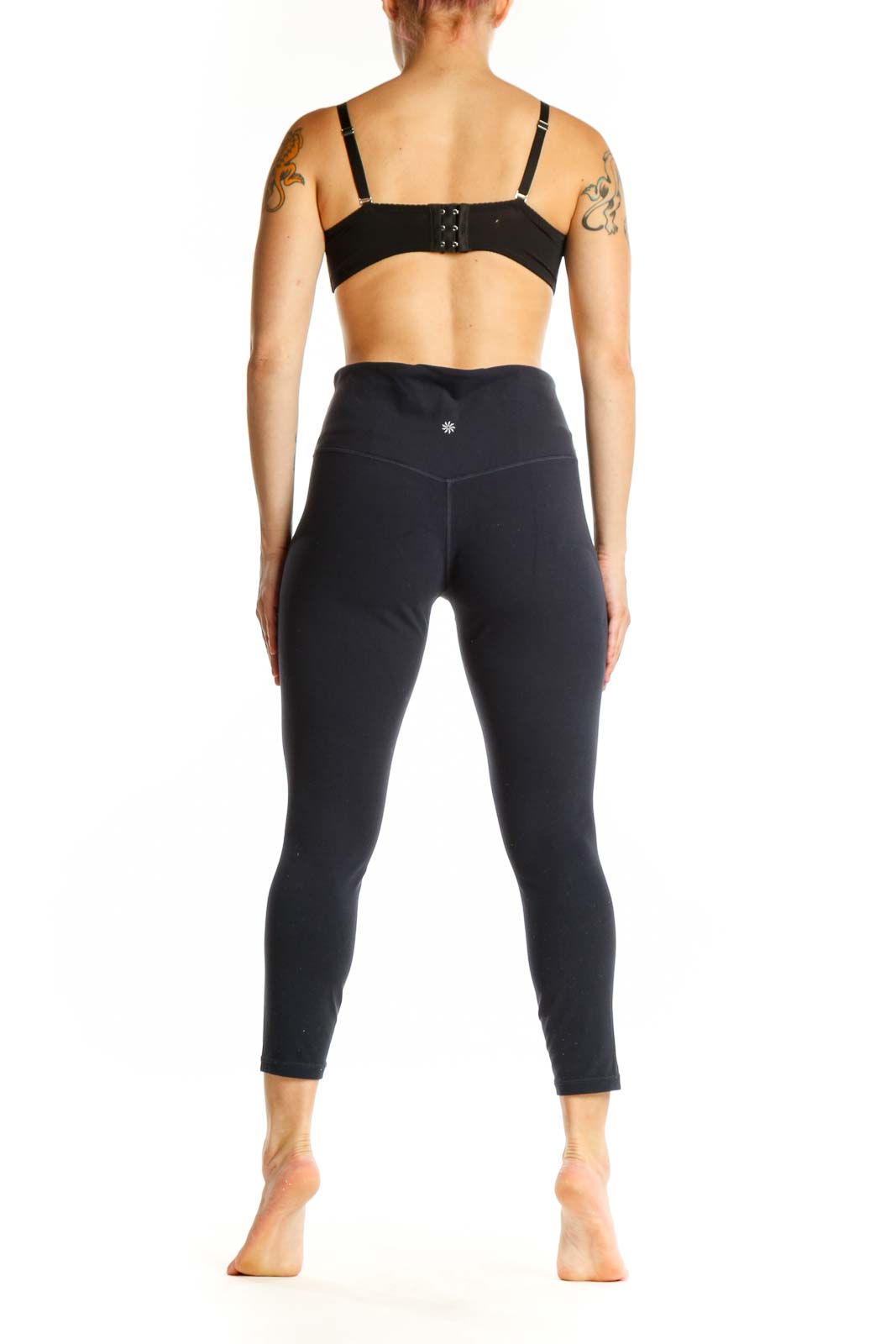 Black high-waist capri leggings back view displaying form-fitting design and cropped length