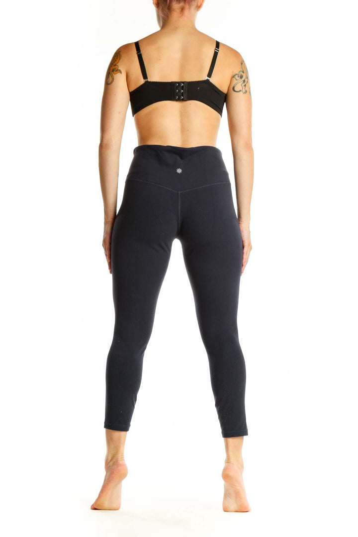 Black high-waist capri leggings back view displaying form-fitting design and cropped length