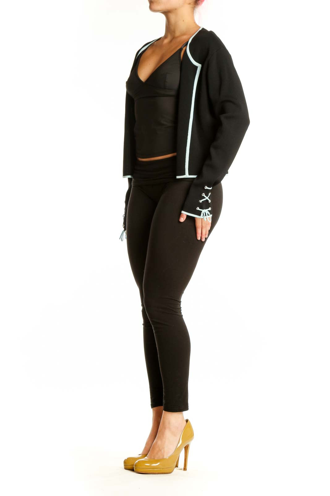Black cropped zip-up jacket with white trim and adjustable cuffs, front view on model
