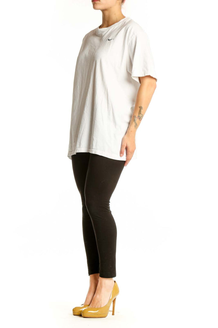 White cotton Nike t-shirt with crew neck and Swoosh logo, front view on model
