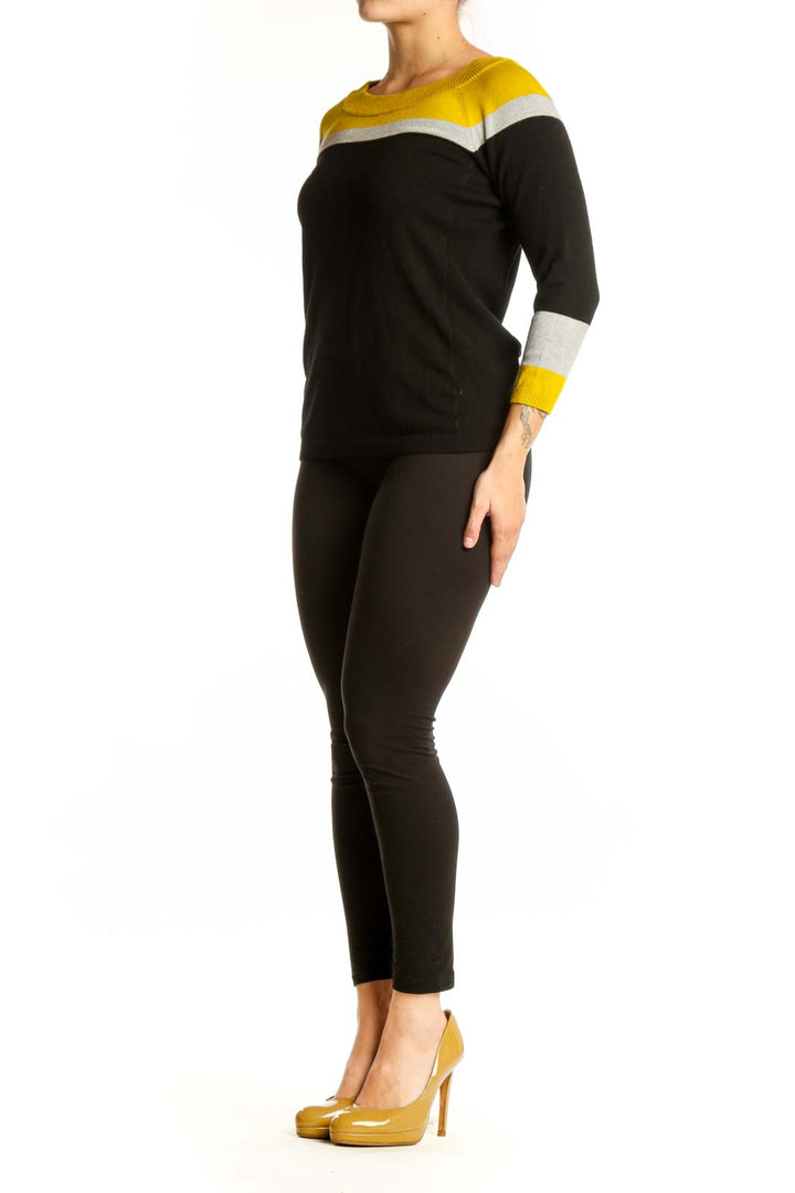 Black and yellow color-block knit sweater with white stripes and three-quarter sleeves, front view