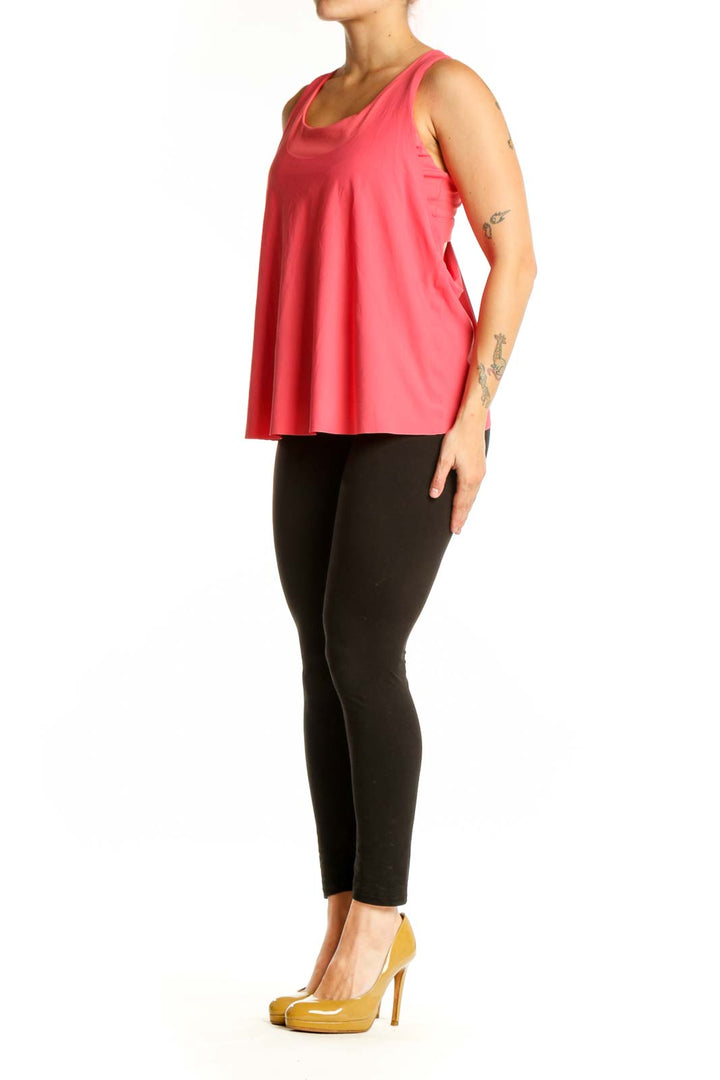 Front view of pink Athleta sleeveless tank top with scoop neckline on model