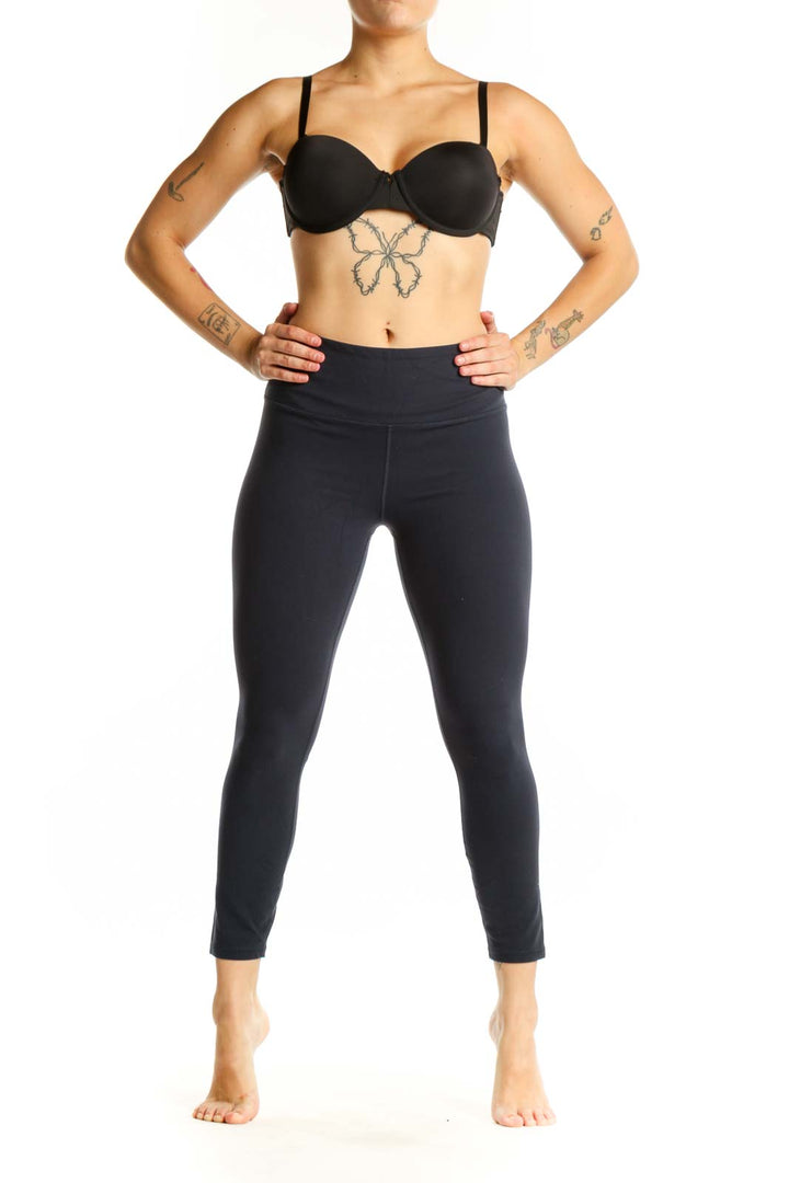 Black Athleta high-waisted capri leggings front view, showcasing form-fitting design and ankle-length cut