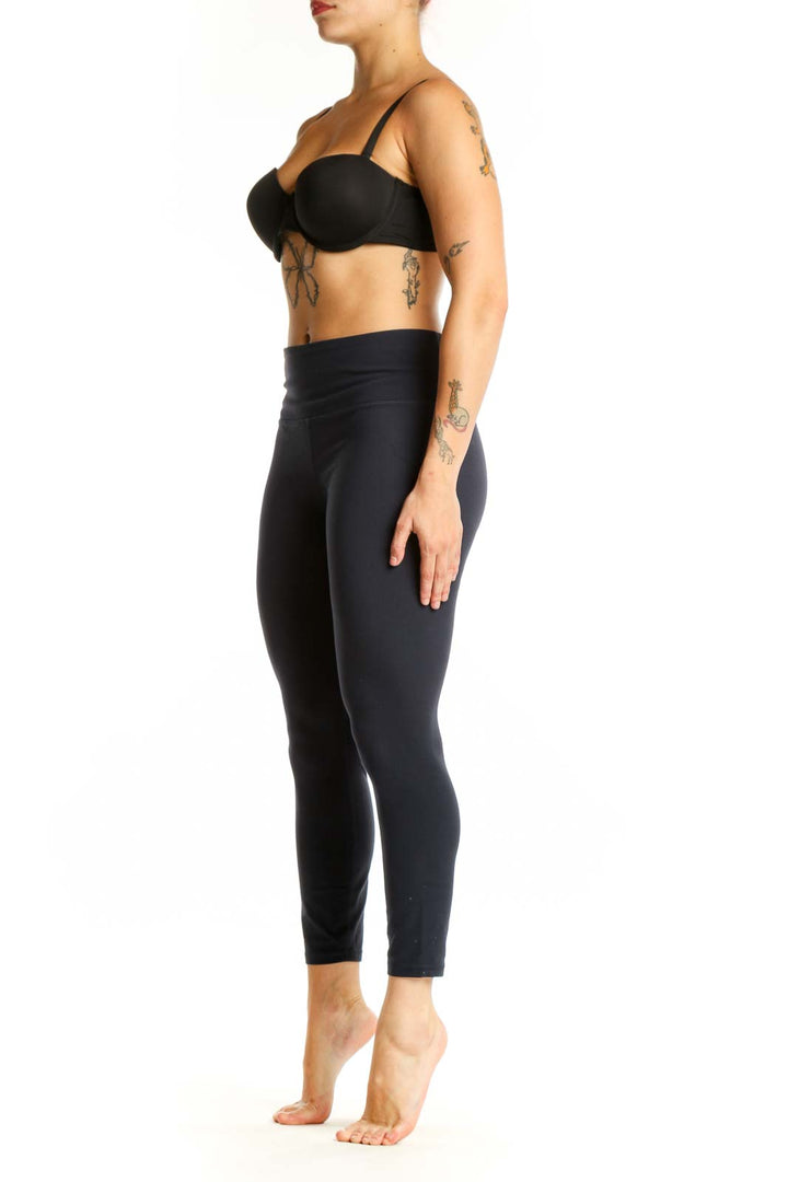 Black Athleta high-waisted capri leggings front view, showcasing form-fitting design and ankle-length cut