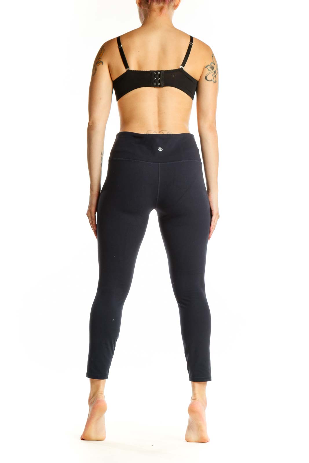 Black Athleta capri leggings back view, displaying high-waisted silhouette and supportive fit