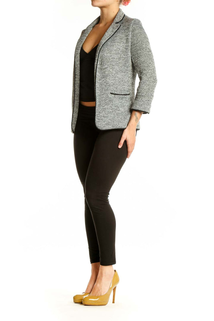 Gray heathered knit blazer with notched lapels and three-quarter sleeves worn over black crop top
