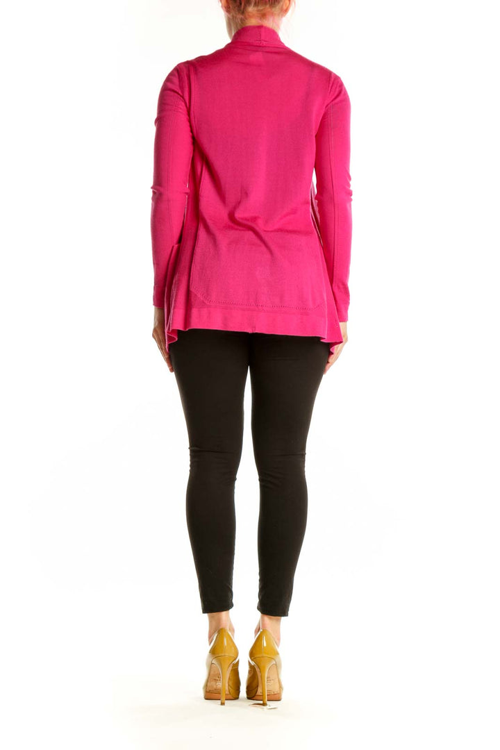 Back view of pink ESCADA cardigan with long sleeves and flowing silhouette, styled with black pants