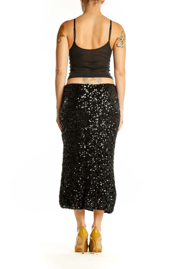 Black sequin midi skirt back view, showing full sequin coverage and elegant silhouette