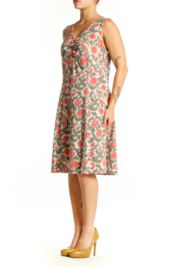 Cream floral midi dress with coral and sage botanical print, V-neckline, sleeveless design, front view