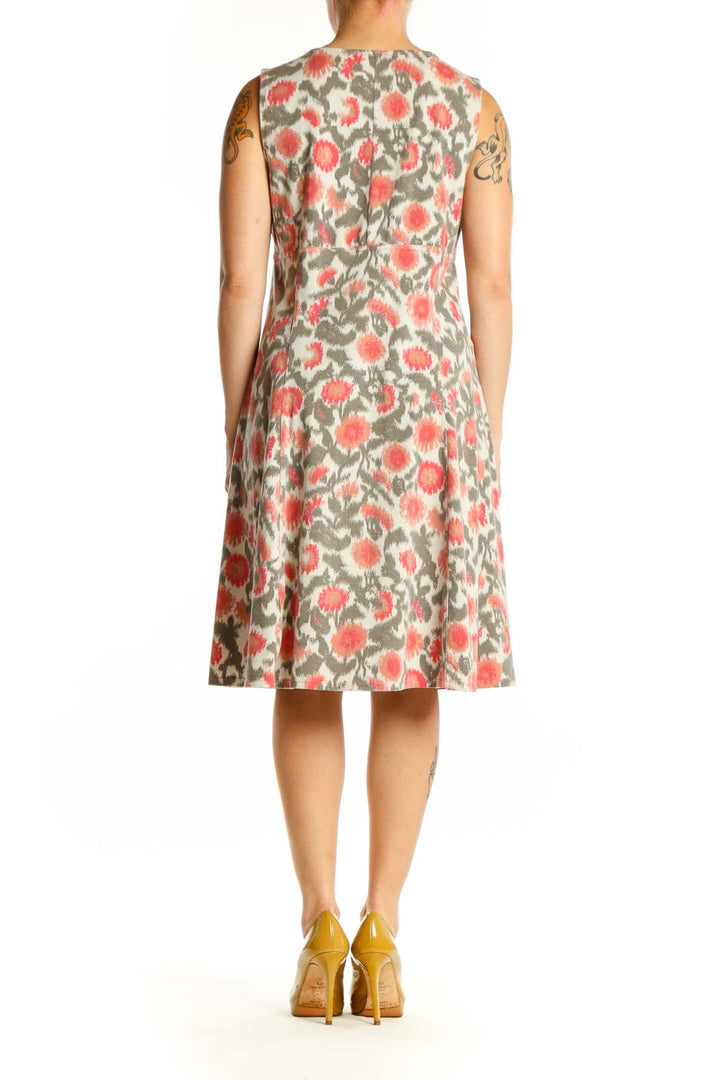 Cream floral midi dress with coral and sage botanical print, V-neckline, sleeveless design, back view