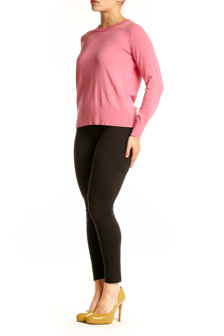 Pink cashmere silk crew neck sweater front view on model wearing black pants