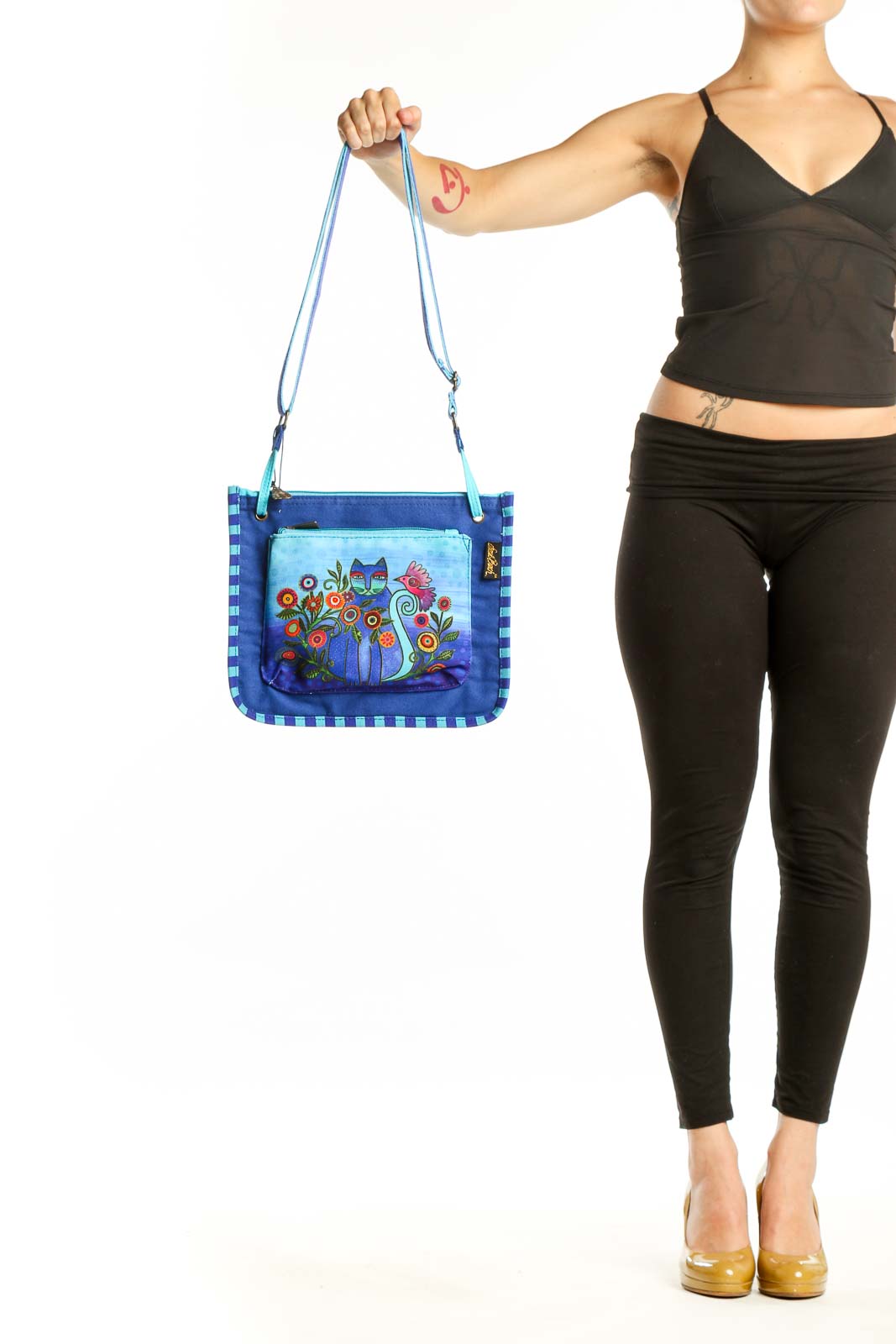 Blue canvas crossbody bag with whimsical floral cat illustration and checkered border pattern