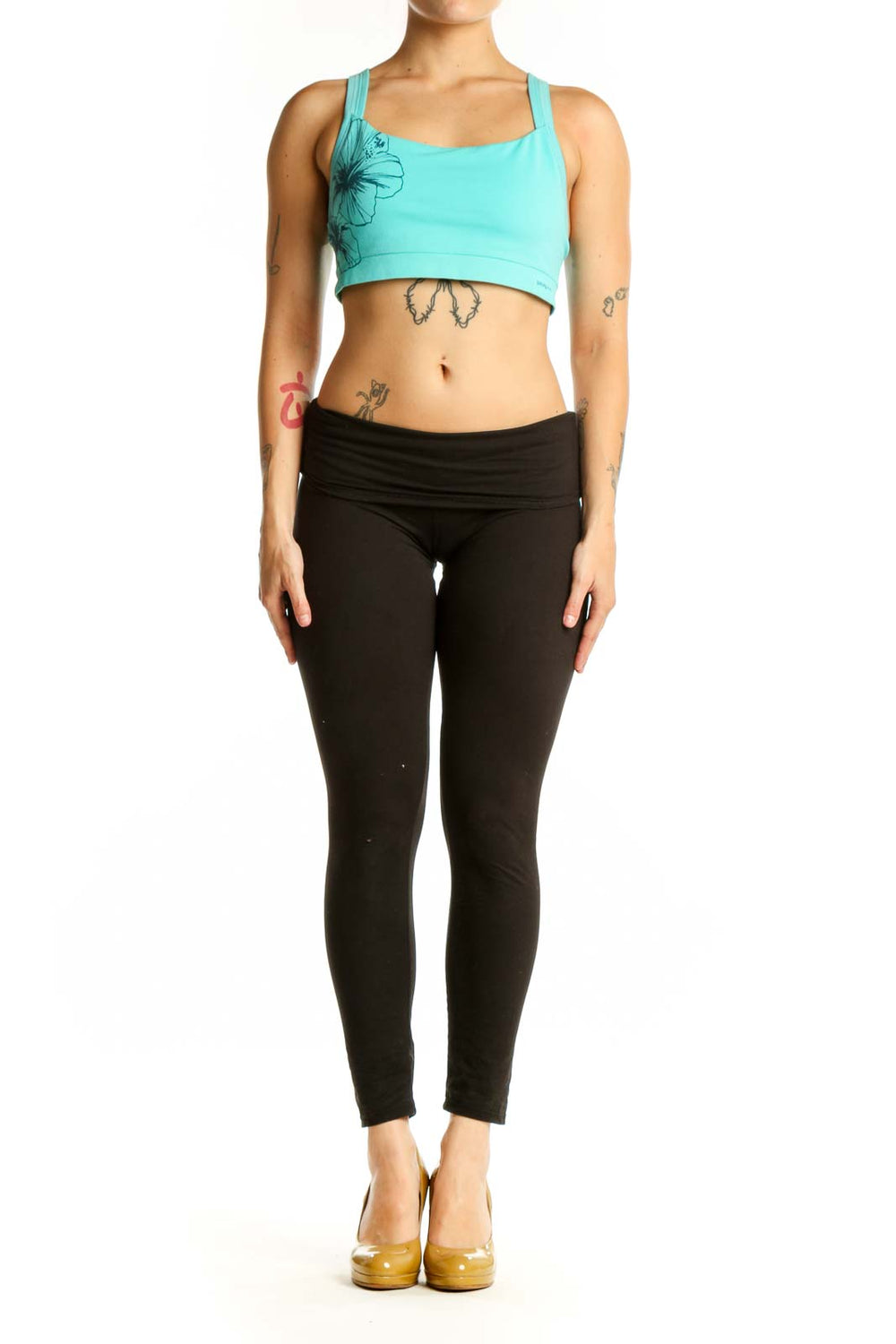 Turquoise floral sports bra front view with black floral line graphic design and wide shoulder straps
