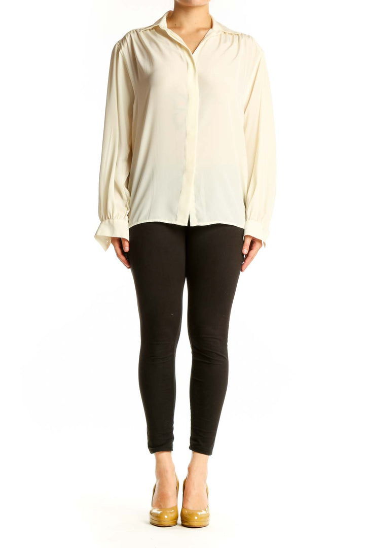 Cream button-up blouse with collared neckline and full-length sleeves, front view