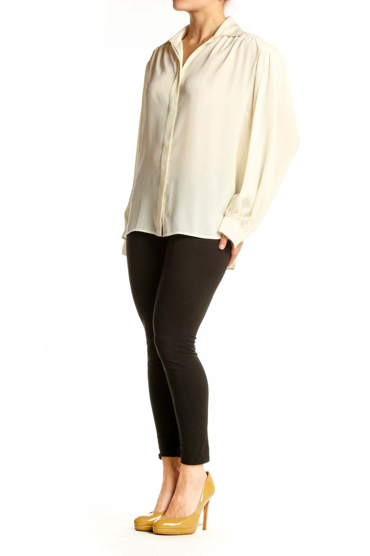Cream button-up blouse with collared neckline and full-length sleeves, front view