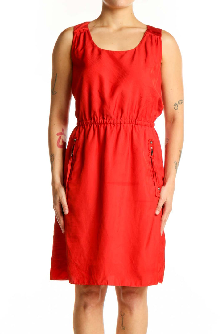 Red sleeveless A-line dress with cinched waist and side pockets, front view
