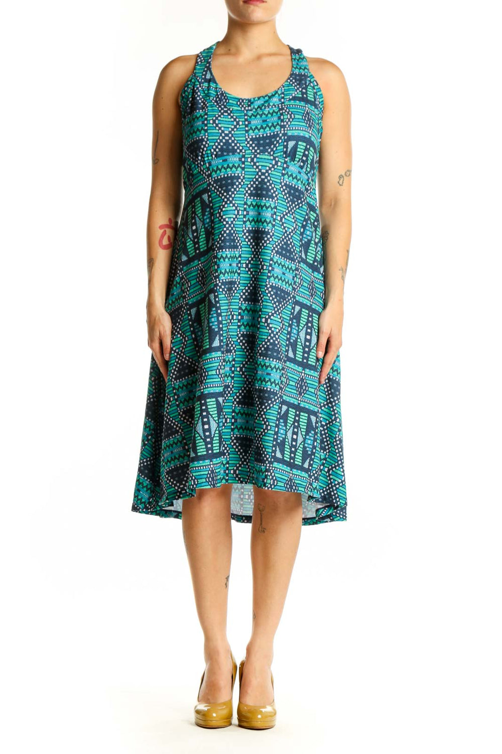 Turquoise and navy geometric halter dress with tribal pattern, front view on model